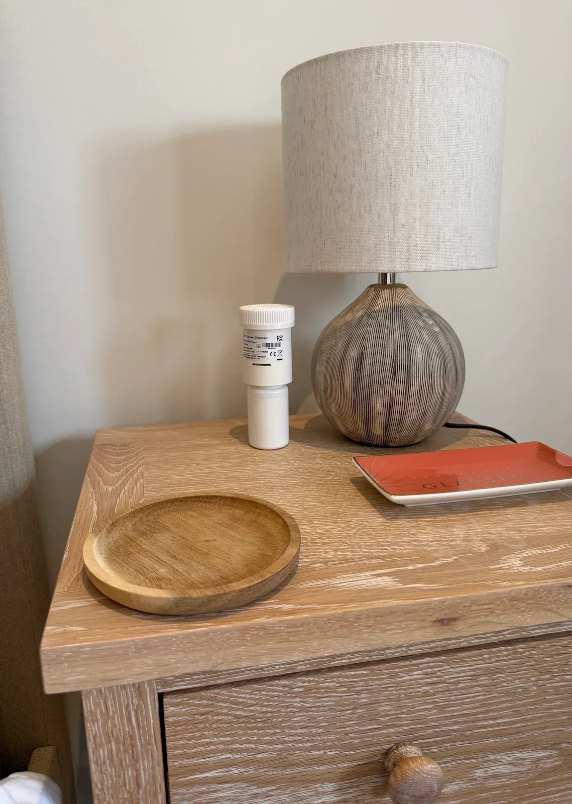 Smart pill dispenser sat on bedside table ready for use